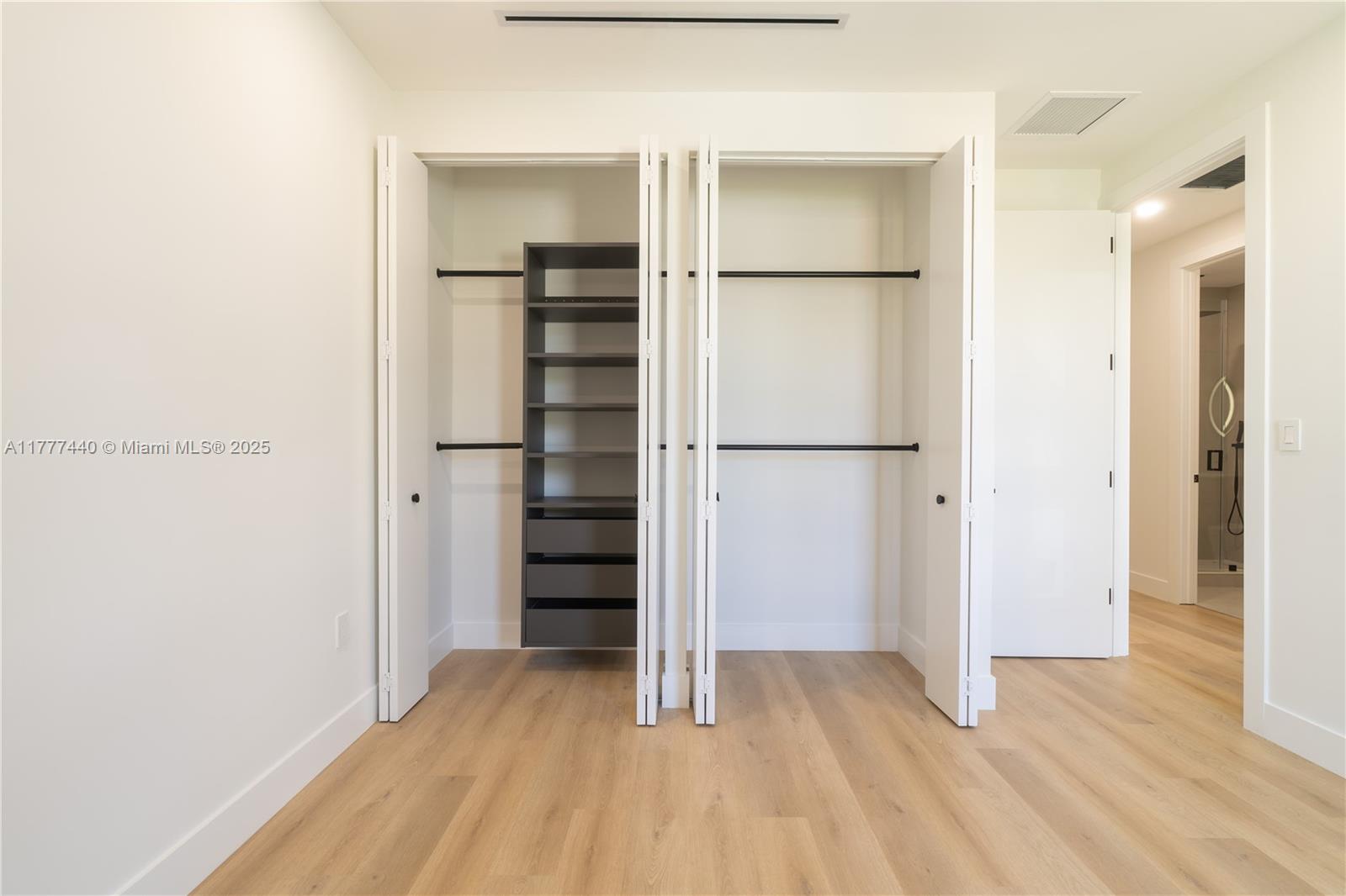 412 Northwest 47th Street Miami, FL 33127 - Photo 43 of 62 a view of walk in closet with empty racks