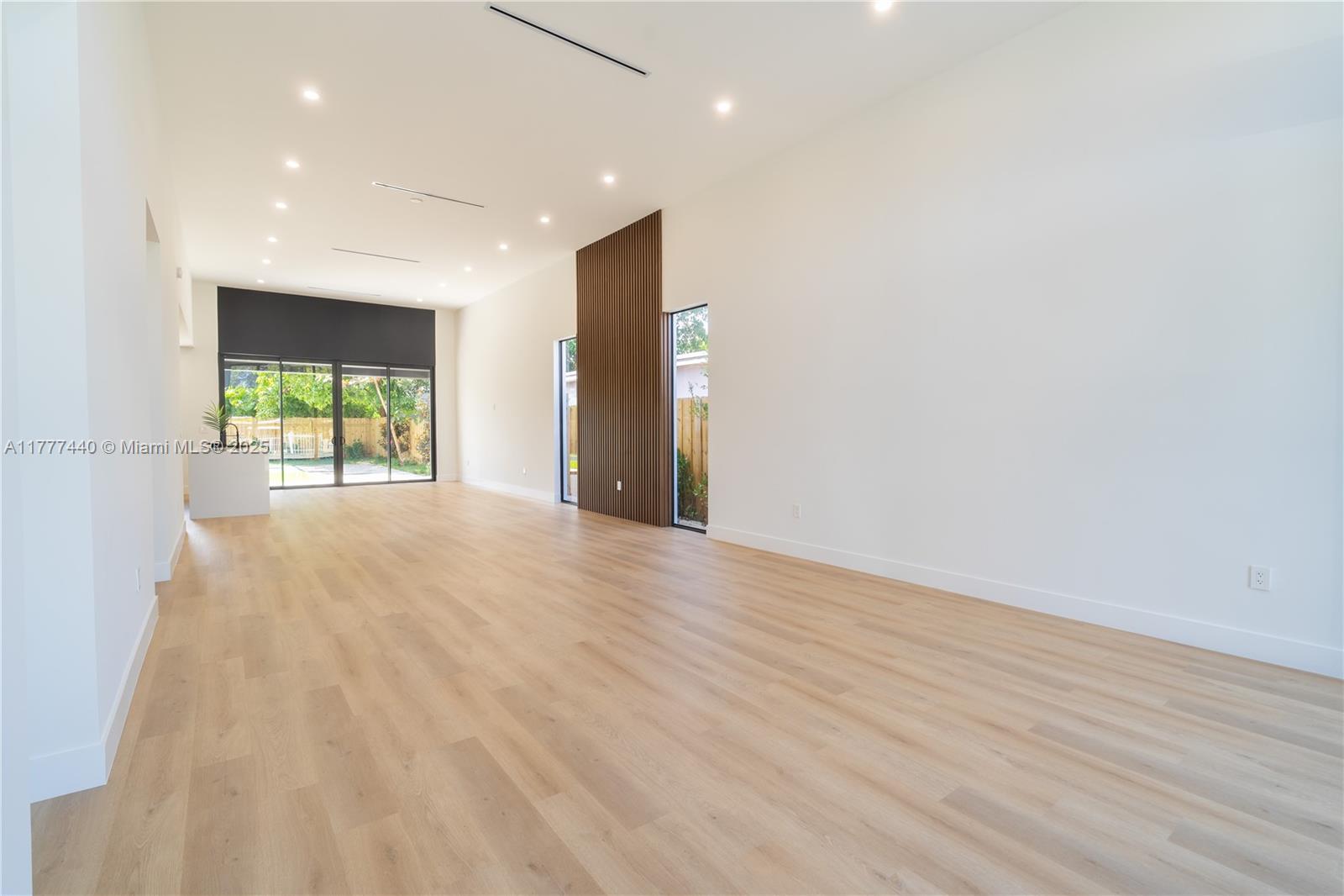 412 Northwest 47th Street Miami, FL 33127 - Photo 5 of 62 an empty room with wooden floor and windows