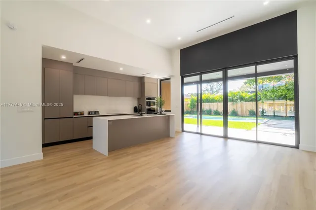 a kitchen with a sink and wooden floor