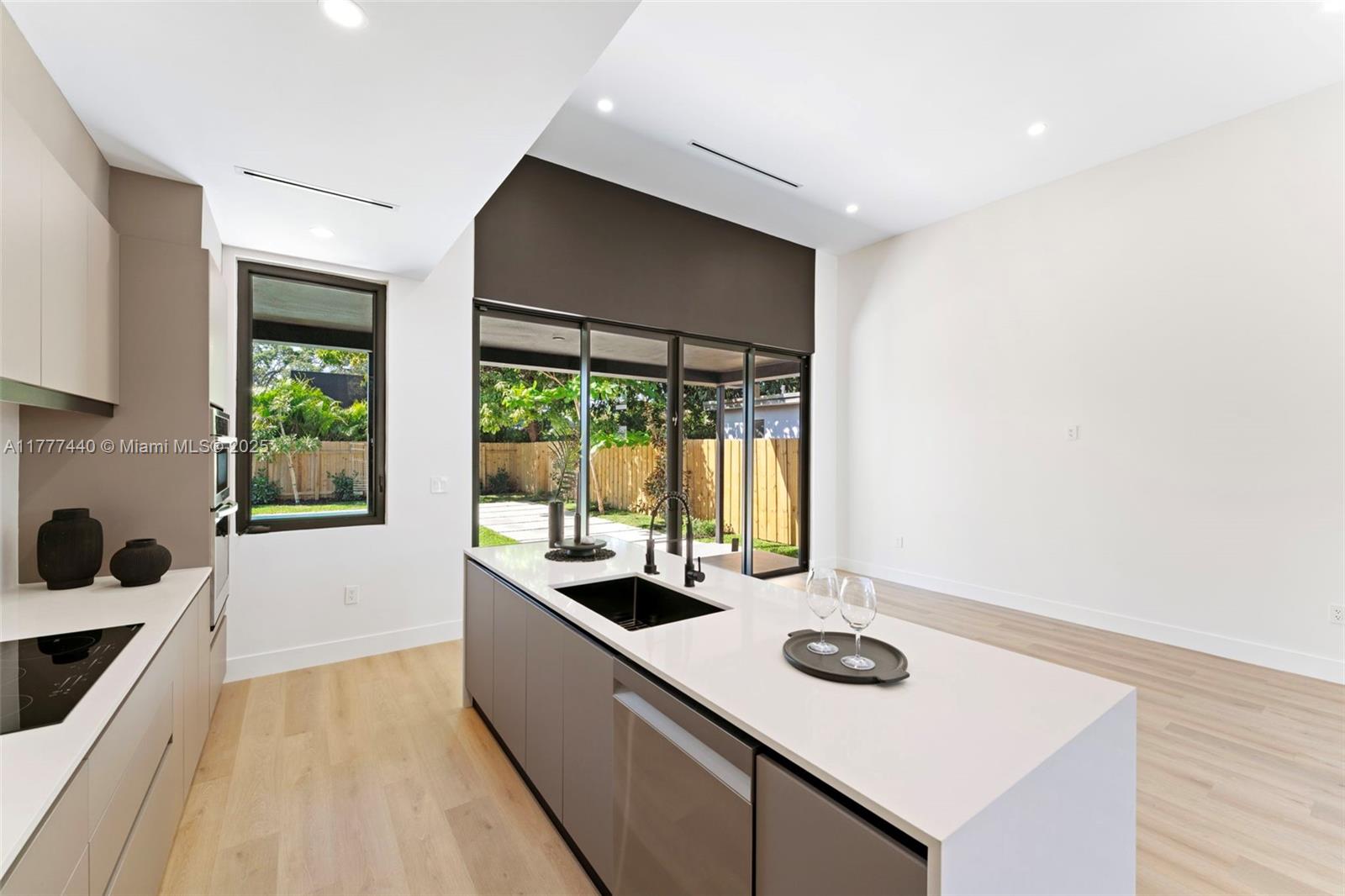 412 Northwest 47th Street Miami, FL 33127 - Photo 10 of 62 a kitchen with a sink and wooden floor