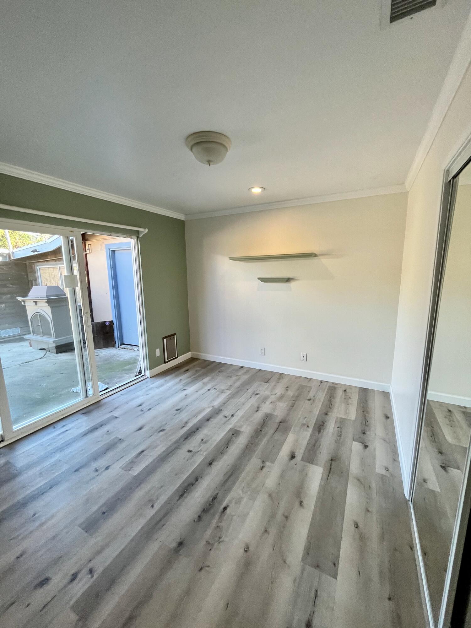 7020 Del Norte Drive Goleta, CA 93117 - Photo 22 of 23 an empty room with wooden floor and door