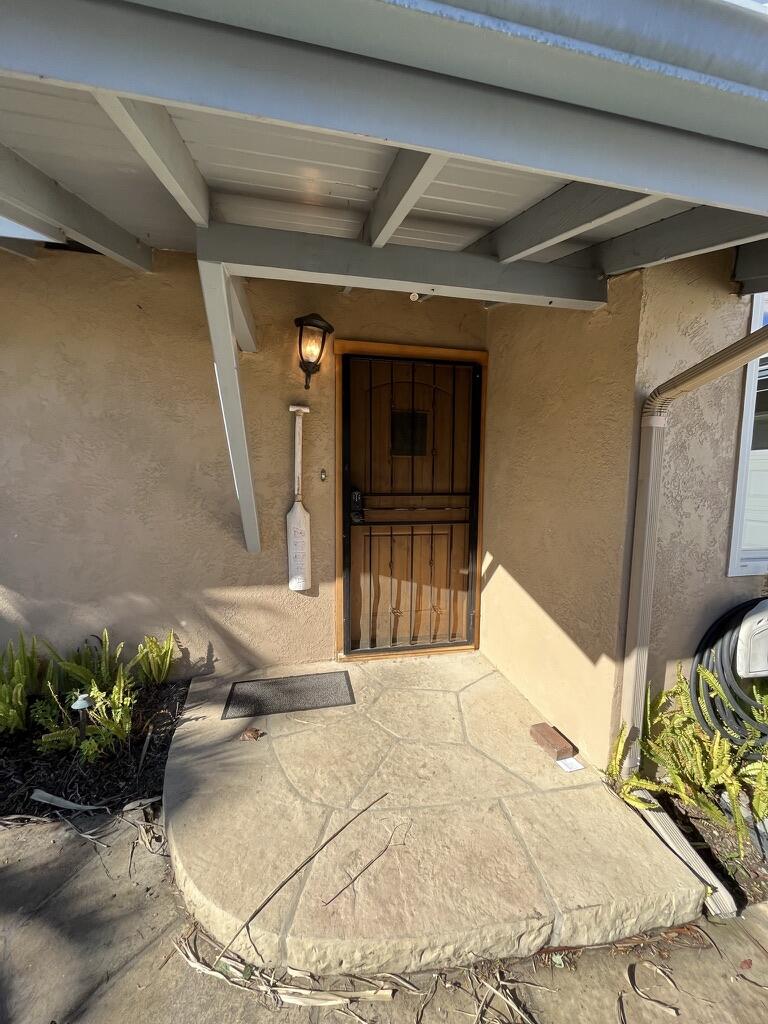 7020 Del Norte Drive Goleta, CA 93117 - Photo 3 of 23 a view of a porch with a table and chairs and potted plants