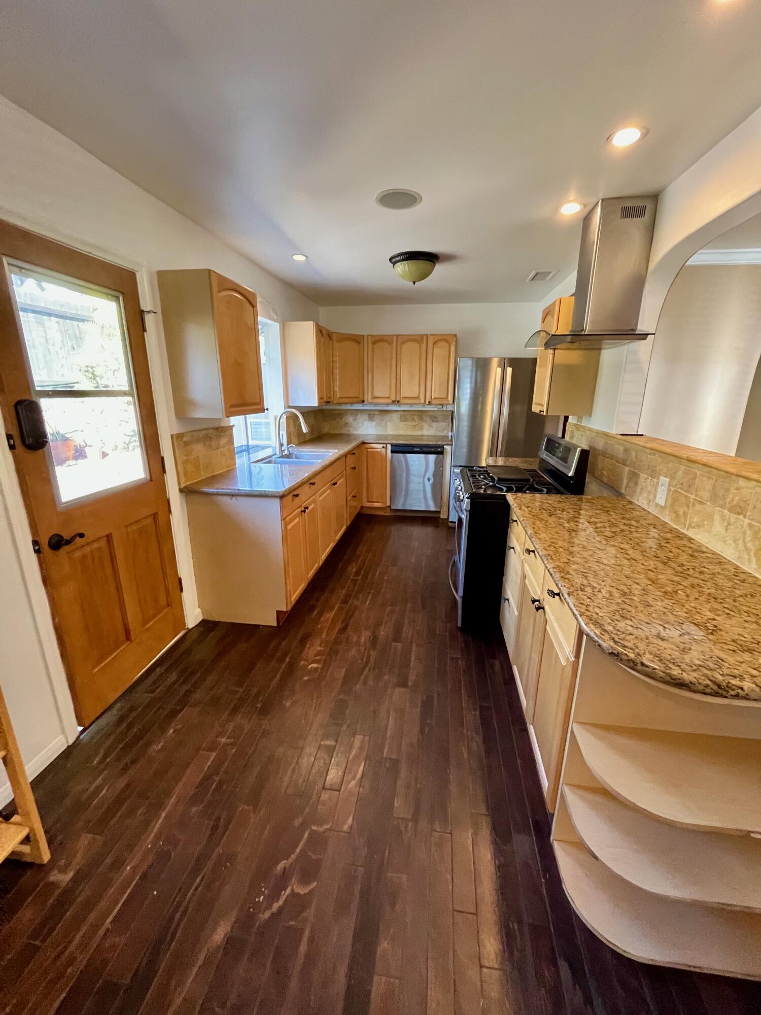 7020 Del Norte Drive Goleta, CA 93117 - Photo 8 of 23 a view of living room kitchen with furniture and wooden floor