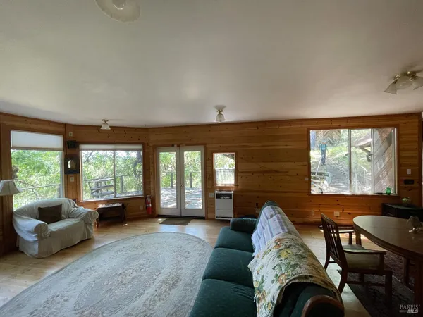 a living room with furniture a rug and a window