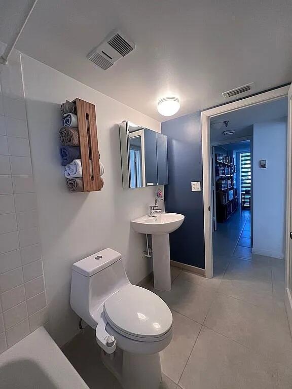 6463 La Costa Drive, Unit 105 Boca Raton, FL 33433 - Photo 17 of 40 a bathroom with a toilet sink and mirror