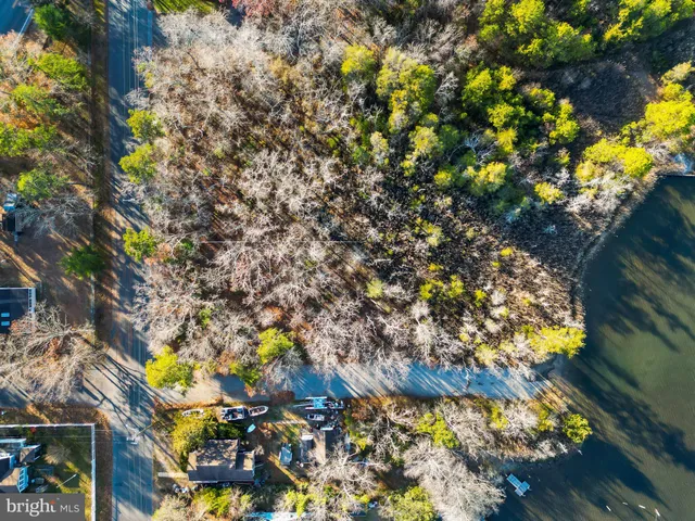 an aerial view of beach and residential houses with outdoor space