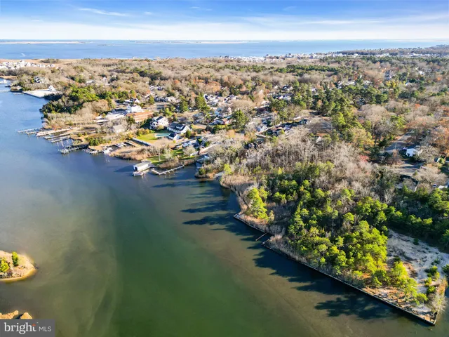 an aerial view of a houses with a lake view