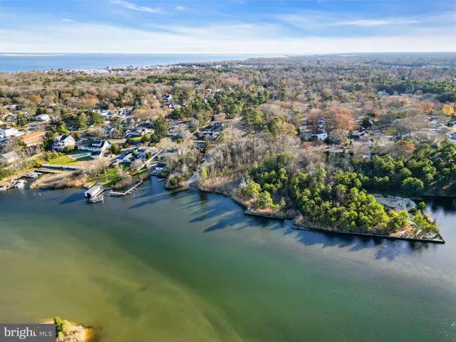 an aerial view of a houses with a yard