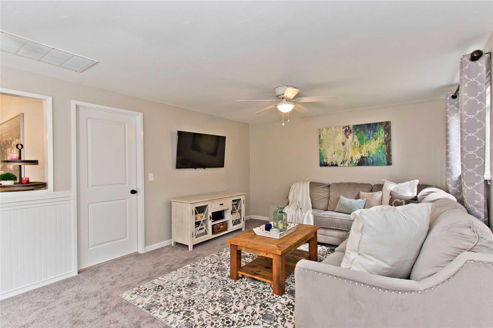 4215 Southeast 3rd Street Renton, WA 98059 - Photo 12 of 30 a living room with furniture a large window and a flat screen tv