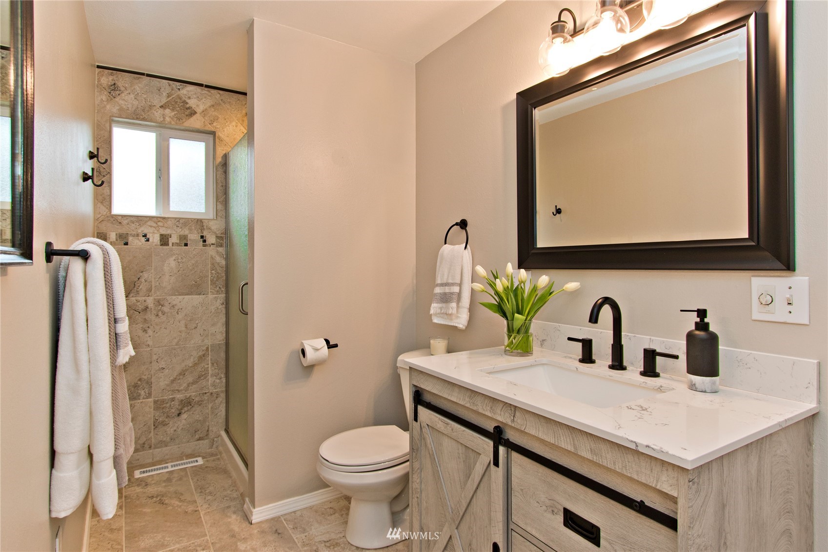 4215 Southeast 3rd Street Renton, WA 98059 - Photo 17 of 30 a bathroom with a granite countertop sink mirror vanity and toilet