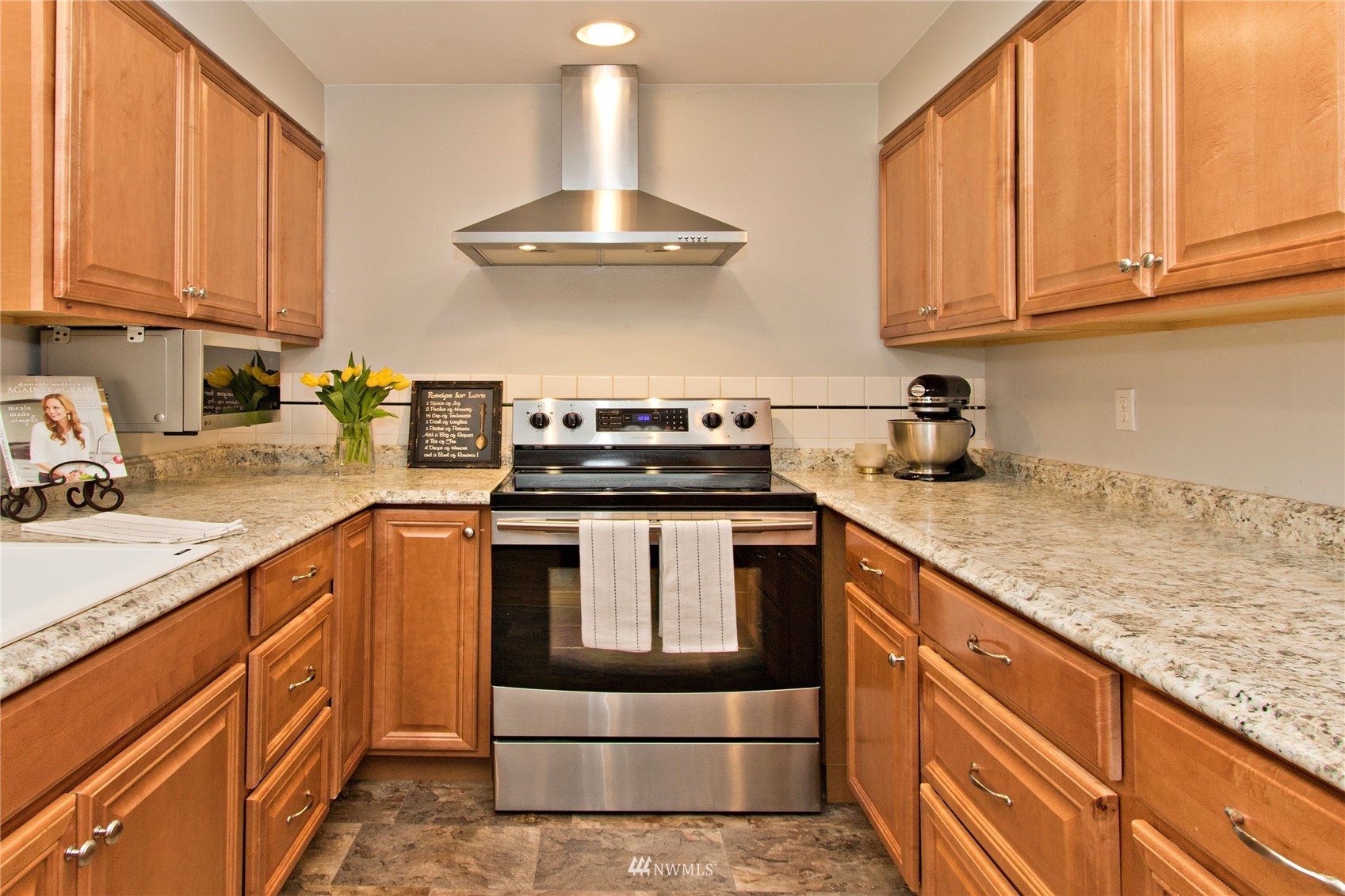 4215 Southeast 3rd Street Renton, WA 98059 - Photo 6 of 30 a kitchen with stainless steel appliances granite countertop a stove a sink and a white cabinets