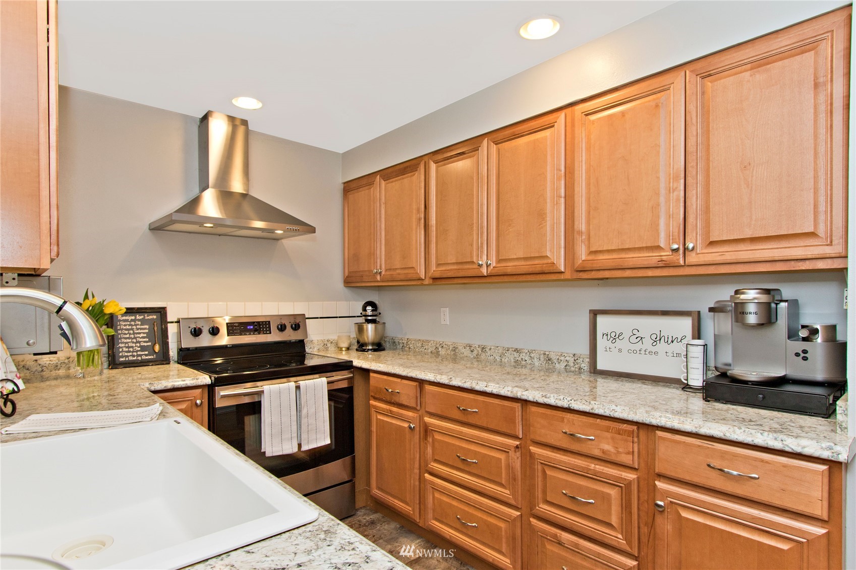4215 Southeast 3rd Street Renton, WA 98059 - Photo 7 of 30 a kitchen with stainless steel appliances granite countertop a sink dishwasher stove and cabinets with wooden floor