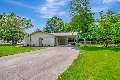 a view of a house with a yard and a garden