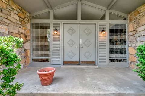 a backyard of house with outdoor seating