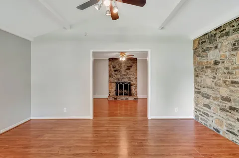 a view of empty room with wooden floor