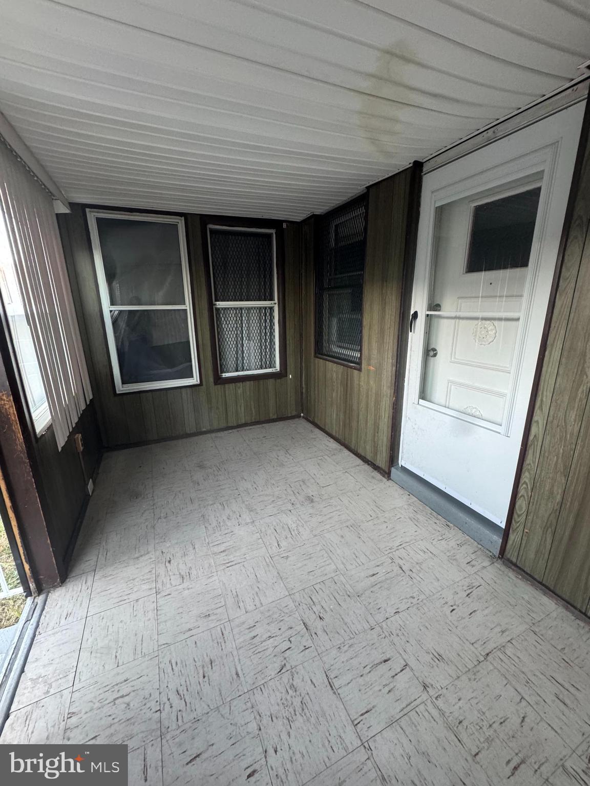 2727 Bookert Drive Baltimore, MD 21225 - Photo 2 of 12 a view of an empty room with a fireplace and a window