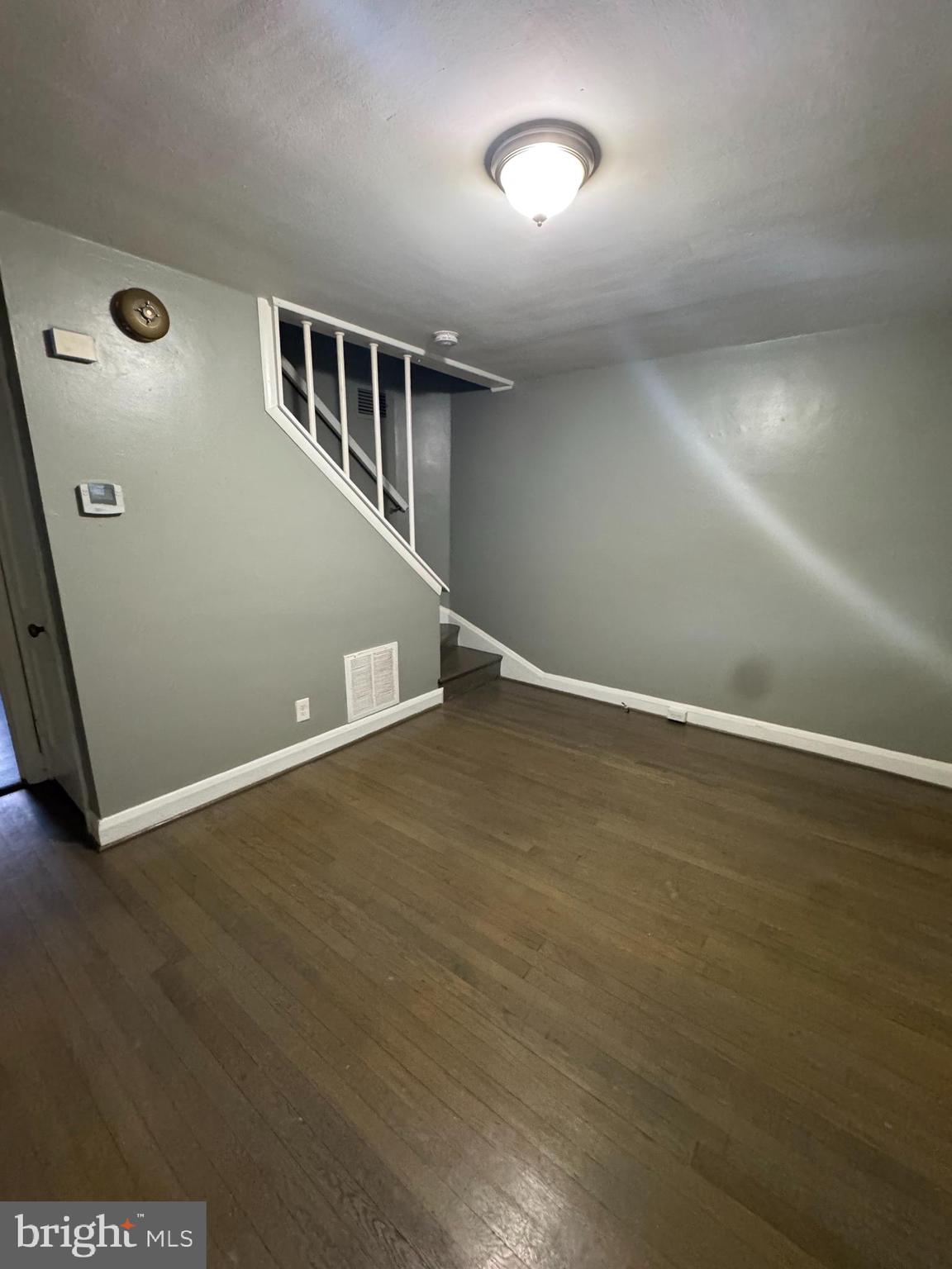 2727 Bookert Drive Baltimore, MD 21225 - Photo 4 of 12 an empty room with wooden floor and windows