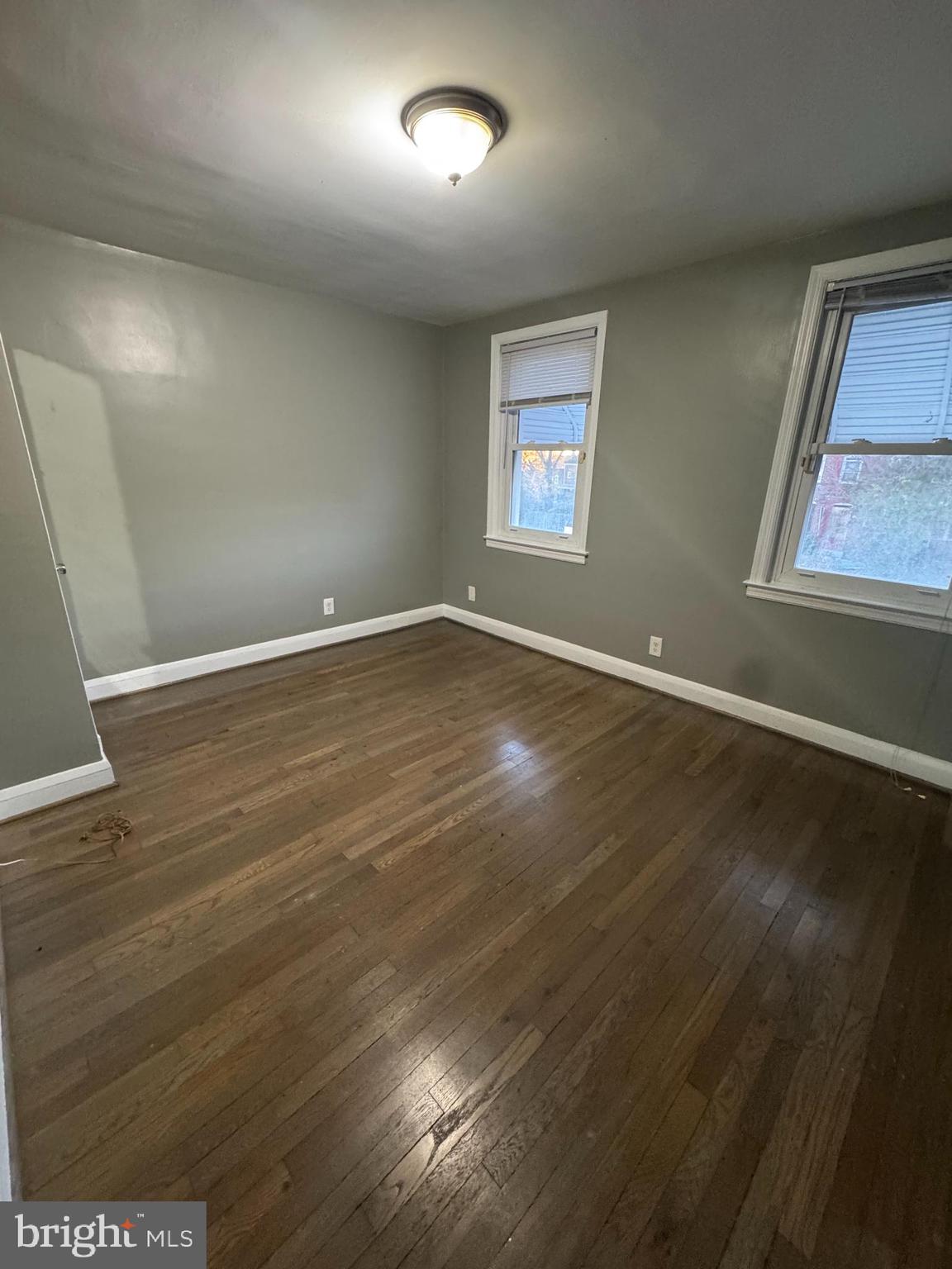 2727 Bookert Drive Baltimore, MD 21225 - Photo 5 of 12 an empty room with wooden floor and windows