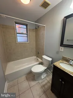a bathroom with a toilet a sink and bathtub