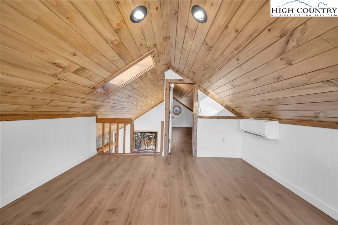 208 Meadow Loop Newland, NC 28657 - Photo 22 of 46 a view of empty room with wooden floor