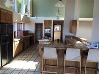 15525 Bohlman Road Saratoga, CA 95070 - Photo 7 of 8 a kitchen with kitchen island granite countertop a table and chairs in it