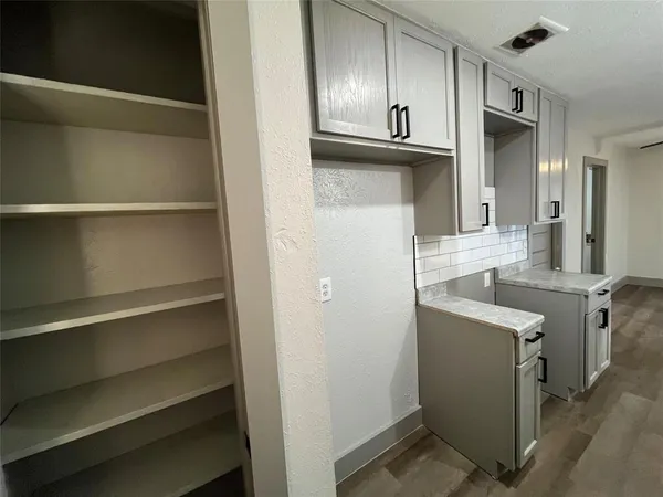 a kitchen with cabinets and stainless steel appliances