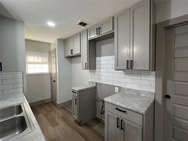 a kitchen with a stove and a sink