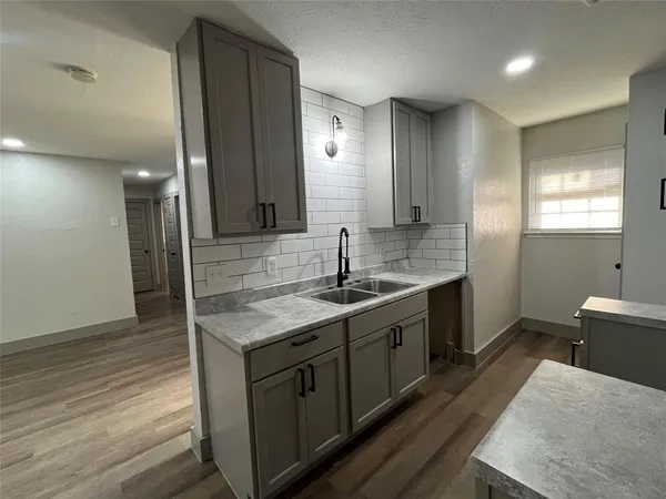 a kitchen with a sink stove and cabinets