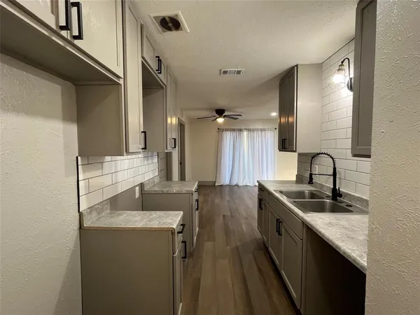 a kitchen with sink refrigerator and stove