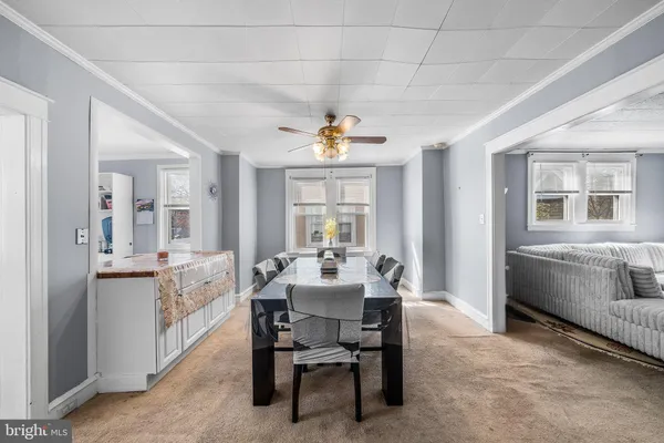 a view of a dining room with furniture and a chandelier