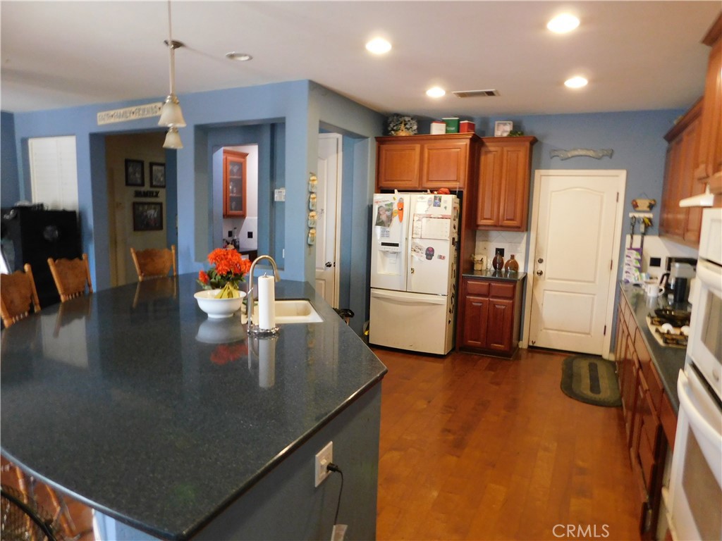 1216 Aups Court Merced, CA 95348 - Photo 11 of 45 a kitchen with sink refrigerator and cabinets