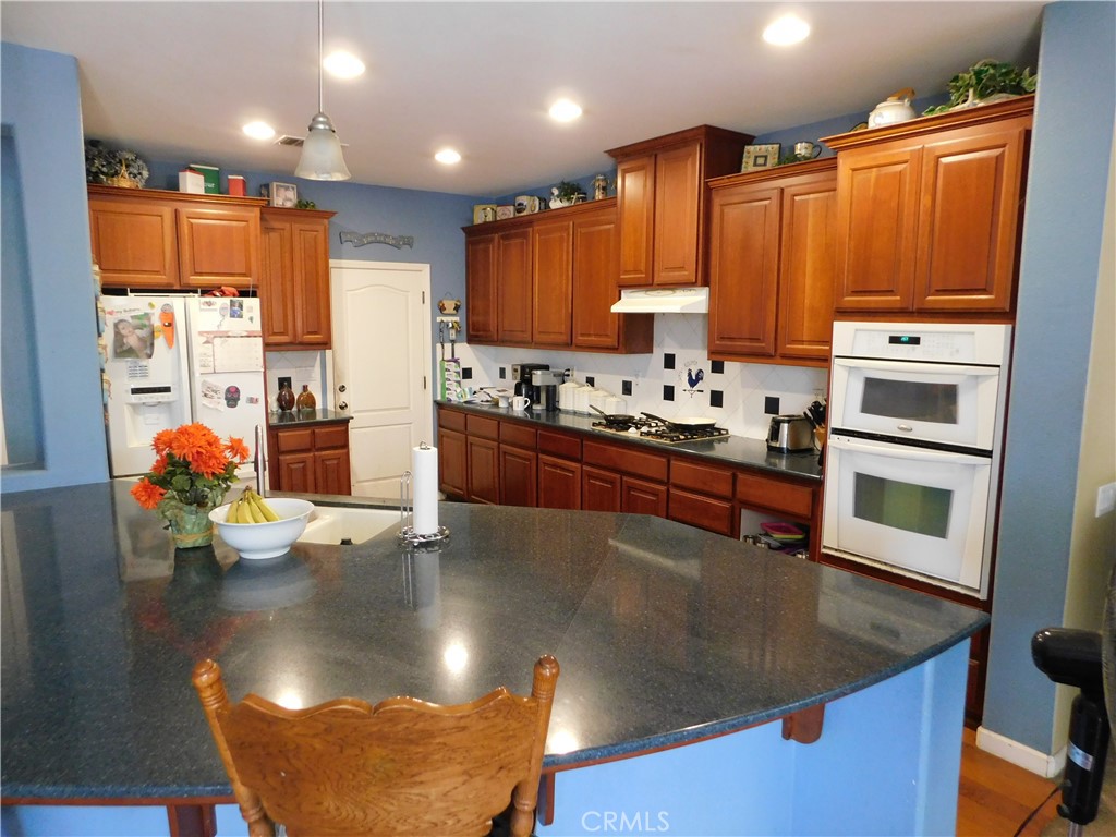 1216 Aups Court Merced, CA 95348 - Photo 12 of 45 a kitchen with stainless steel appliances granite countertop a sink stove and refrigerator