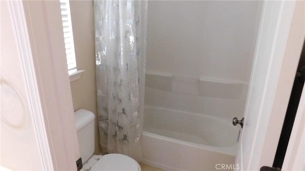1216 Aups Court Merced, CA 95348 - Photo 31 of 45 a bathroom with a shower and a toilet