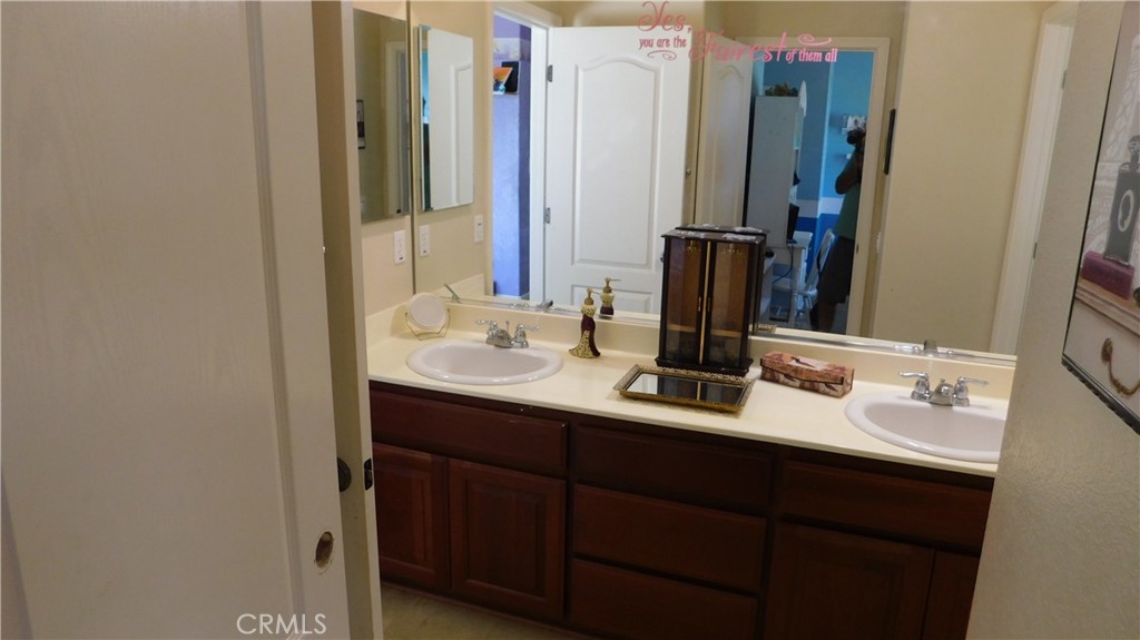1216 Aups Court Merced, CA 95348 - Photo 32 of 45 a bathroom with double vanity sinks and a mirror