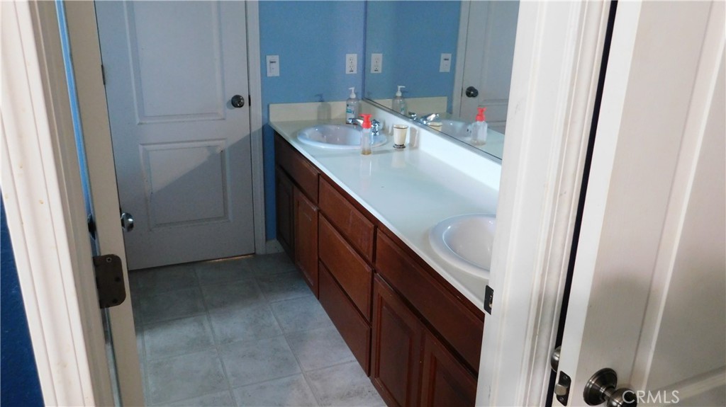 1216 Aups Court Merced, CA 95348 - Photo 38 of 45 a bathroom with a sink and mirror