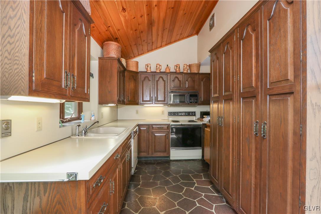 1271 Kilmer Road Tobyhanna, PA 18466 - Photo 17 of 36 a kitchen with stainless steel appliances a sink a stove a refrigerator and cabinets