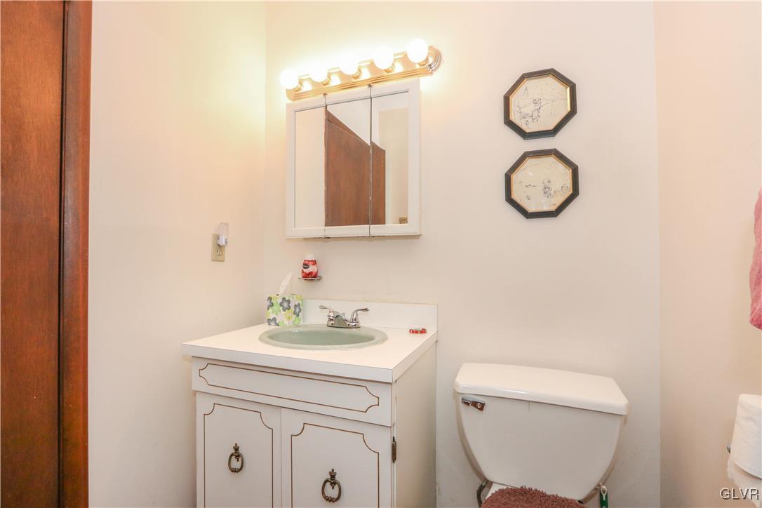 1271 Kilmer Road Tobyhanna, PA 18466 - Photo 20 of 36 a bathroom with a toilet sink vanity and mirror
