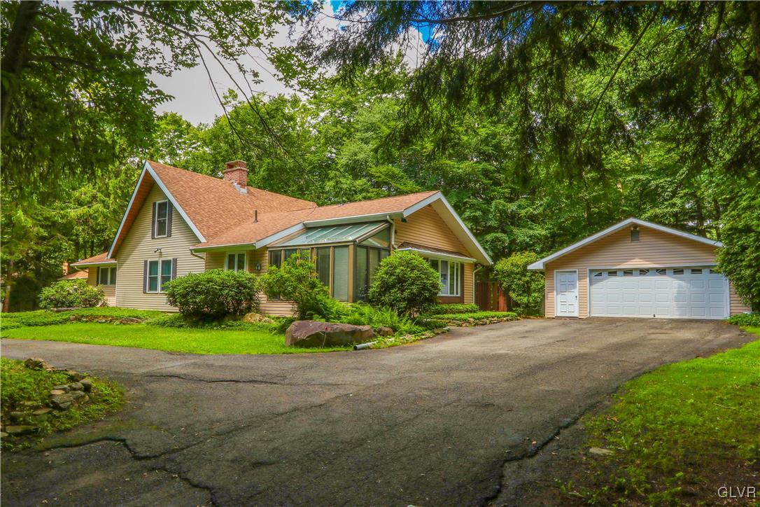 1271 Kilmer Road Tobyhanna, PA 18466 - Photo 2 of 36 a front view of a house with a yard and garage