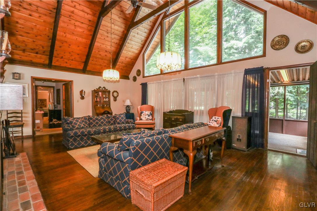 1271 Kilmer Road Tobyhanna, PA 18466 - Photo 6 of 36 a living room with furniture floor to ceiling window and wooden floor