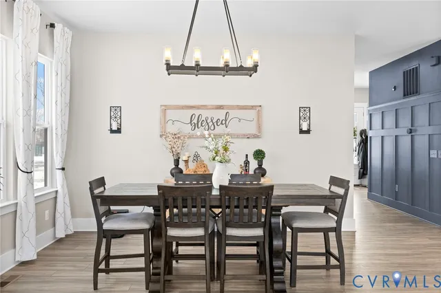 a view of a dining room with furniture and wooden floor