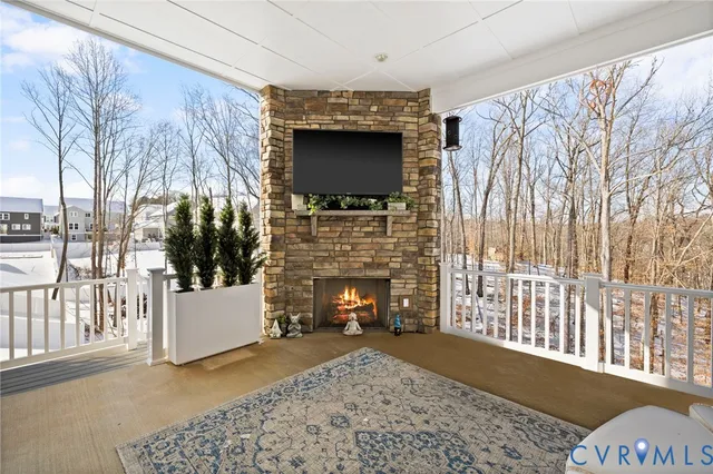 a living room with a fireplace and a flat screen tv