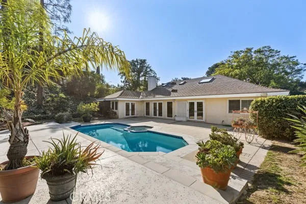 a front view of a house with swimming pool having outdoor seating