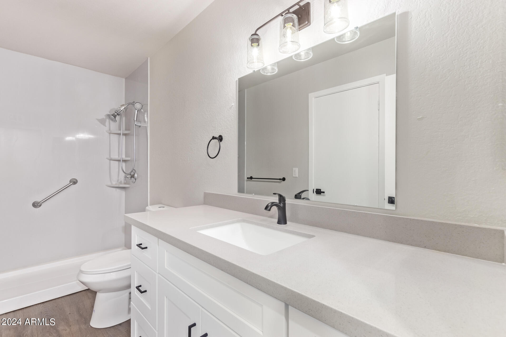 7231 West Flower Street Phoenix, AZ 85033 - Photo 11 of 22 a bathroom with a sink a toilet and a mirror
