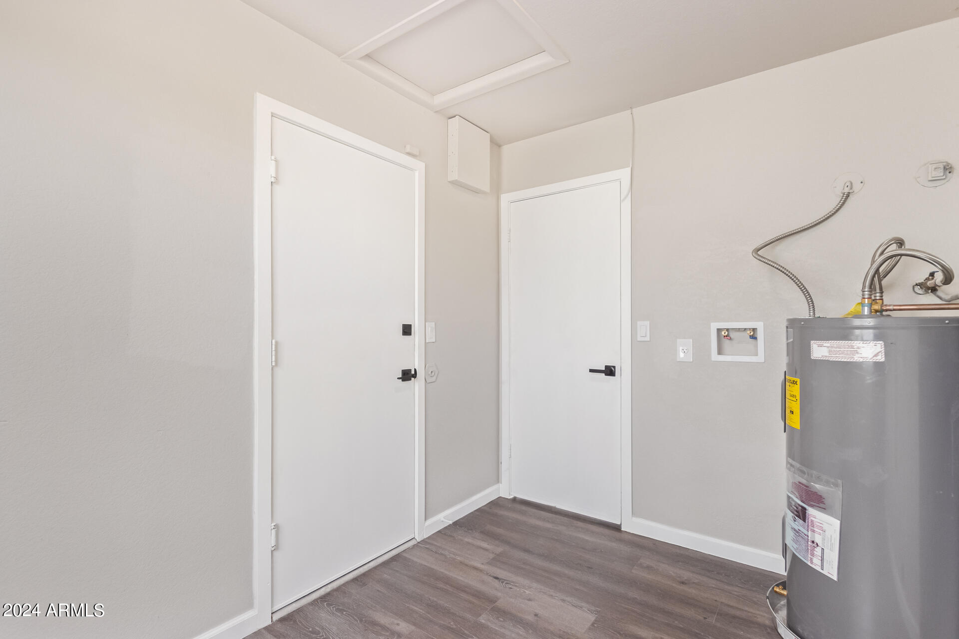 7231 West Flower Street Phoenix, AZ 85033 - Photo 15 of 22 a view of an empty room with wooden floor