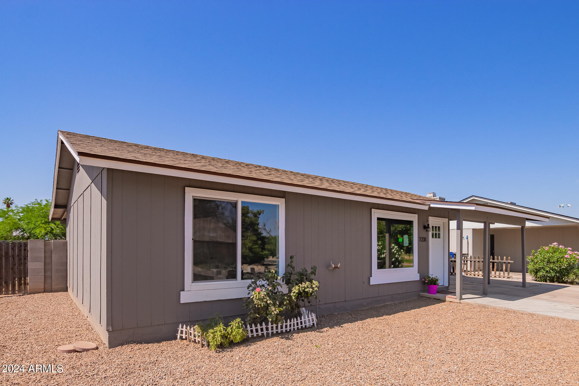 7231 West Flower Street Phoenix, AZ 85033 - Photo 2 of 22 a front view of a house with a garden