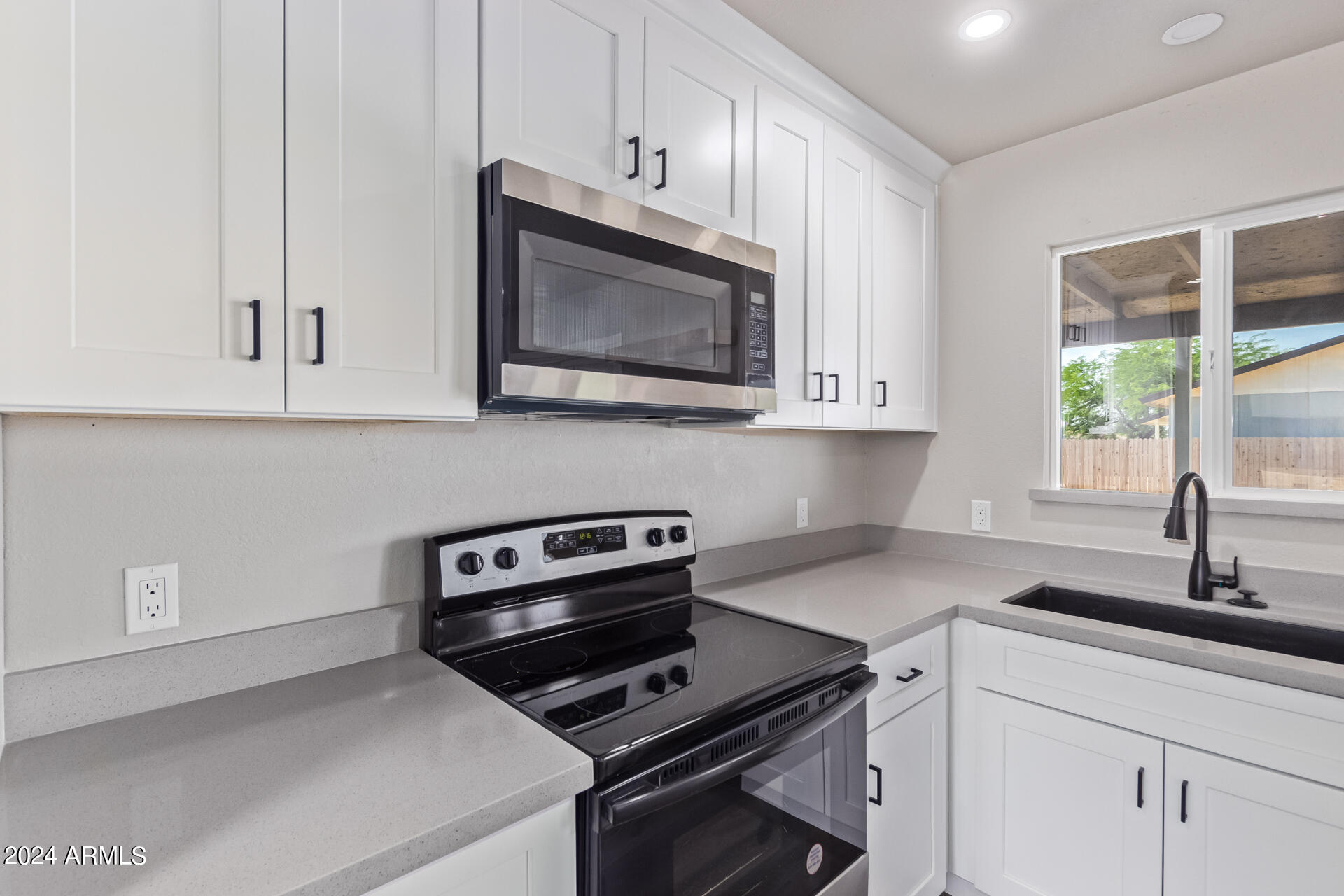 7231 West Flower Street Phoenix, AZ 85033 - Photo 5 of 22 a kitchen with appliances a sink and cabinets