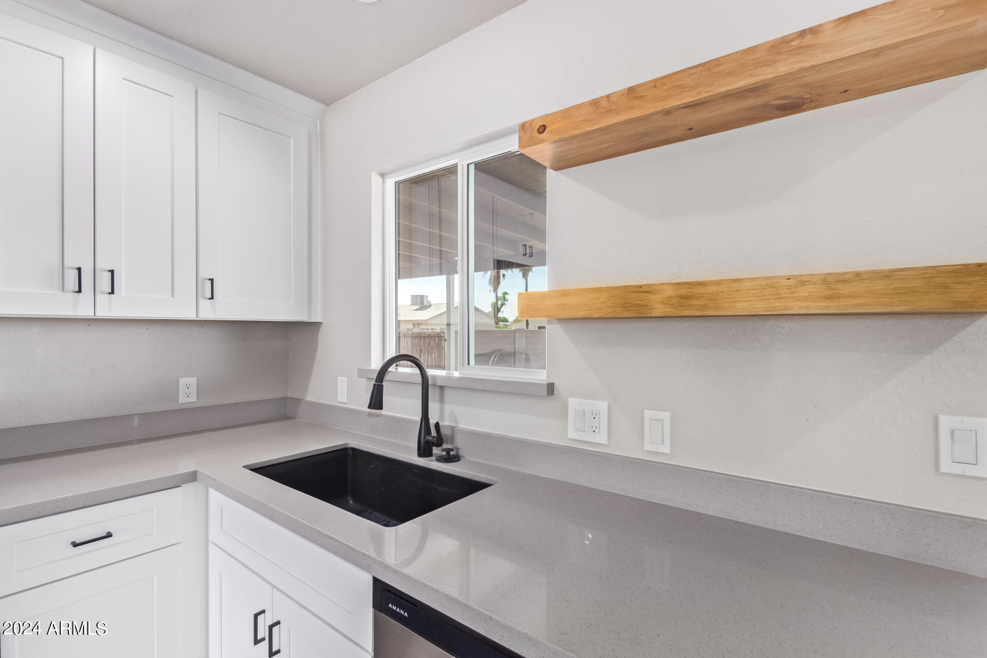 7231 West Flower Street Phoenix, AZ 85033 - Photo 6 of 22 a kitchen with a sink and cabinets