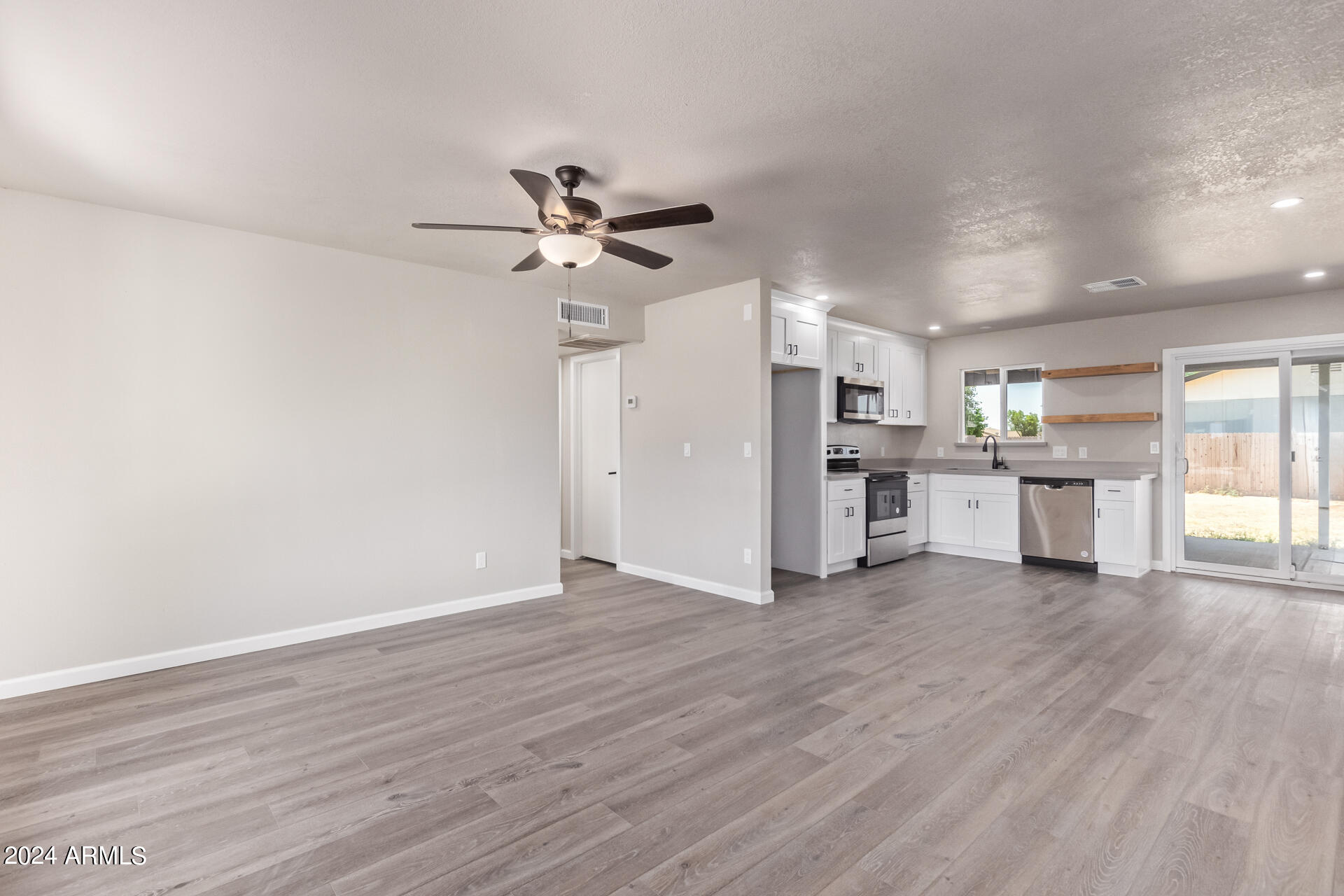 7231 West Flower Street Phoenix, AZ 85033 - Photo 8 of 22 a view of a kitchen with a dishwasher cabinets and wooden floor