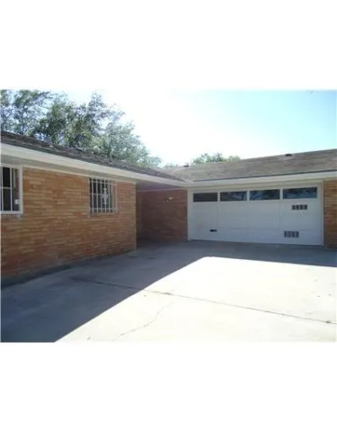 a view of potted plants in backyard of house