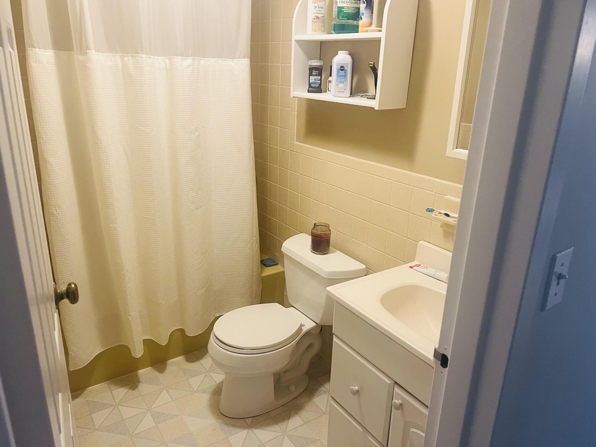 1431 Iyannough Road, Unit 1 Centerville, MA 02632 - Photo 12 of 28 a white toilet sitting next to a small sink